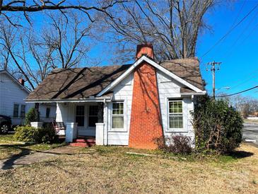 Charming bungalow with a brick chimney and a cozy front porch under a clear blue sky at 441 Hope St, Rock Hill, SC 29730