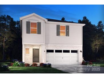 Inviting two-story home featuring white siding, brick accents, and an attached two-car garage at 912 Smithcliffs Trl, York, SC 29745