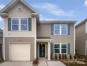 Charming two-story home with a one-car garage, neutral siding, and attractive window shutters at 9645 Hanberry Blvd # 47, Charlotte, NC 28213