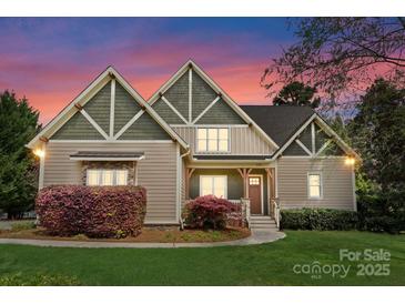 Charming home featuring well-manicured lawn and craftsman-style details and pleasing color scheme at 132 Tuskarora Point Ln, Mooresville, NC 28117
