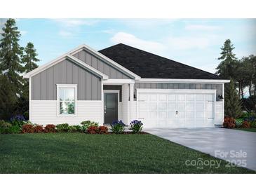 Charming single-story home showcasing a well-manicured lawn, a two-car garage and a blend of gray and white siding at 1418 Windy Park Dr, Stanley, NC 28164