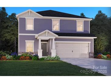 Charming two-story home with a two-car garage, landscaped front yard, and welcoming entrance at 1424 Windy Park Dr, Stanley, NC 28164