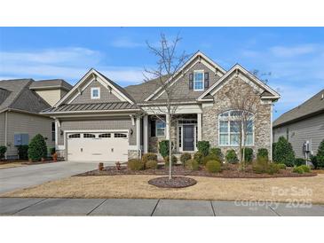 Charming home featuring stone accents, neutral siding, a well-maintained lawn, and an attached two-car garage at 14629 Glen Valley Ct, Charlotte, NC 28278