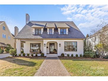 Charming white-brick home featuring a manicured front yard and a welcoming brick pathway at 1816 Beverly Dr, Charlotte, NC 28207