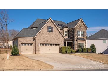 Charming brick and stone home with a three-car garage, perfect for a growing Gathering at 865 Kathy Dianne Dr, Fort Mill, SC 29707