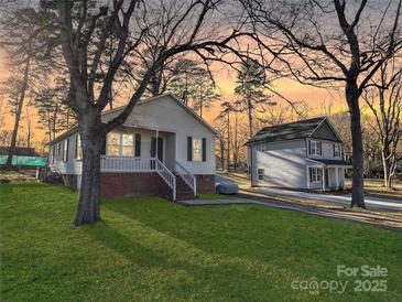 Charming home with a well-manicured lawn and an inviting porch for relaxing evenings at 1304 Browdis Ave, Kannapolis, NC 28083