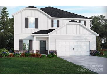 Charming two-story home featuring white siding, a stone foundation, a two-car garage, and a well-manicured lawn at 1414 Windy Park Dr, Stanley, NC 28164