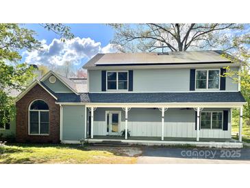 Charming two-story home with solar panels, front porch and black shutters at 1589 E Lakewood Dr, Rock Hill, SC 29732