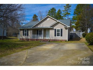 Charming one-story home featuring neutral siding, black shutters, a cozy front porch, and a well-manicured lawn at 1660 Ashridge Rd, Rock Hill, SC 29730