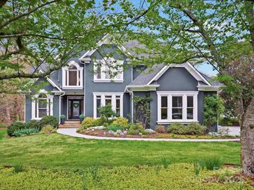 Beautiful two-story home with a blue exterior, well-manicured lawn, and charming curb appeal at 19000 Hodestone Mews Ct, Davidson, NC 28036