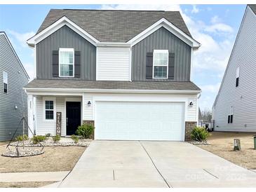 Charming two-story home with a welcoming front porch, two-car garage, and a well-maintained lawn at 2847 Legacy Ridge Ln, Catawba, NC 28609