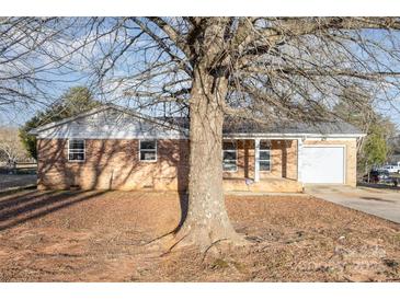 Charming brick ranch-style home featuring an attached garage and covered front porch at 2888 Robinson Rd, Newton, NC 28658