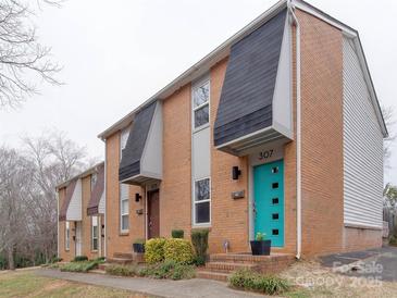 Brick townhouse exterior showcasing a row of homes with tidy landscaping and colorful doors at 307 French St, Charlotte, NC 28216