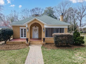 Charming brick home featuring a manicured lawn, covered entryway, and attractive landscaping at 333 7Th Nw St, Hickory, NC 28601
