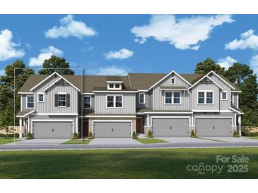 Charming townhome with a two-car garage and Craftsman-style facade and shuttered windows at 117 Alluvium Ln, Waxhaw, NC 28173