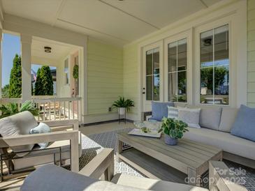 Inviting covered patio features stylish outdoor seating, a patterned rug, and elegant decor for relaxation at 1538 Riverwalk Pkwy, Rock Hill, SC 29730