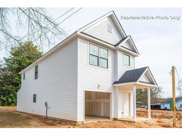 New construction home featuring white vinyl siding, attached one car garage and covered front porch at 160 S Sycamore St, Mooresville, NC 28115