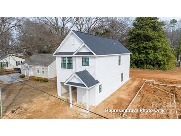 New construction featuring white siding and dark roof with a covered front entryway and attached garage at 162 S Sycamore St, Mooresville, NC 28115