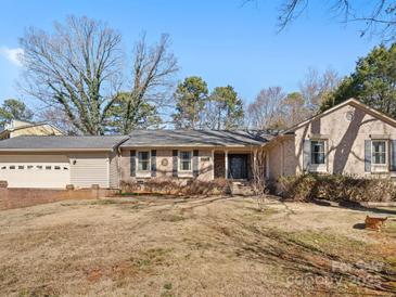 Charming brick ranch-style home with mature trees and an attached two-car garage at 3142 Wimbledon Ln, Rock Hill, SC 29732