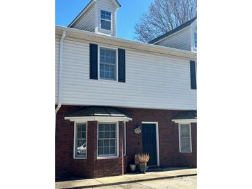 Charming townhouse featuring a brick facade, black shutters, and a welcoming front entrance at 405 Wilson N St, Rock Hill, SC 29730