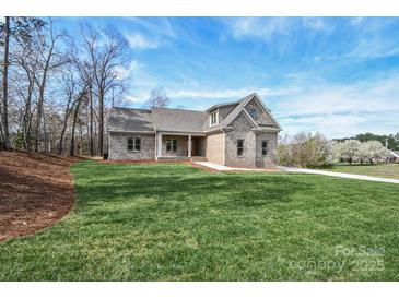 Charming brick home with a well-manicured lawn and beautiful landscaping, offering great curb appeal at 1202 Louise Ln, Albemarle, NC 28001