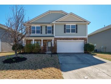 Charming two-story home with a well-maintained front yard and attached two-car garage at 12820 Settlers Trail Ct, Charlotte, NC 28278