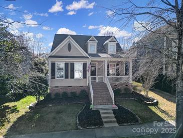 Charming two-story home featuring a welcoming front porch and well-maintained landscaping at 224 Mills Ln, Fort Mill, SC 29708