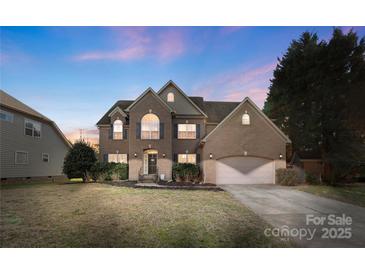 Charming brick two-story home with well-maintained landscaping and attached two-car garage at 2283 Iron Works Dr, Clover, SC 29710