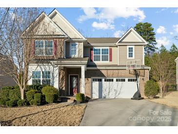Two-story home featuring brick accents, a two-car garage, well-maintained landscaping, and a basketball hoop on the driveway at 241 Catoctin Rd, Rock Hill, SC 29732