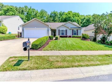 Charming single-story home with a well-manicured lawn, neatly trimmed bushes, and a two-car garage at 2627 Bridgeville Ln, Charlotte, NC 28262
