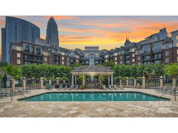 Resort-style pool area with a gazebo and lounge chairs in a luxury community with a skyline view at 300 W 5Th St # 711, Charlotte, NC 28202