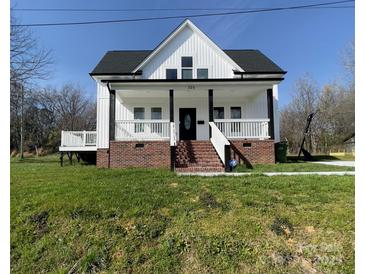 Charming two-story home with a welcoming front porch and brick foundation in a landscaped yard at 320 City Ave, Lancaster, SC 29720