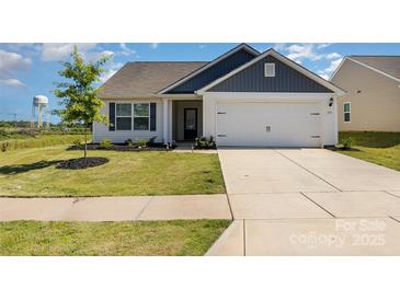 Charming single-story home featuring a two-car garage and well-manicured front lawn at 324 Aniston Ln, Shelby, NC 28152