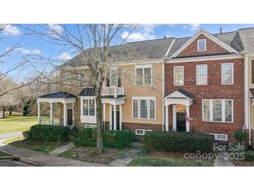 Charming townhomes with landscaped front yards, covered entrances, and a mix of brick and siding facades at 582 Sixth Baxter Xing, Fort Mill, SC 29708