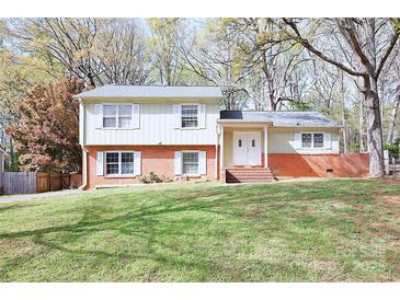 Charming two-story home with brick accents and a well-manicured front lawn at 7515 Riding Trail Rd, Charlotte, NC 28212