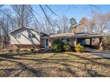 Charming split-level home featuring brick accents, vinyl siding, a welcoming front porch and covered carport at 8080 Monbo Rd, Catawba, NC 28609