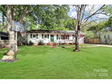 Charming single-story home with a well-maintained lawn and a basketball hoop in the front yard at 908 Dogwood Dr, Gastonia, NC 28054