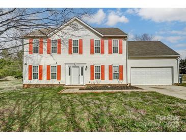 Charming two-story home with red shutters and a well-manicured front yard at 9900 Meadowmead Ct, Charlotte, NC 28273