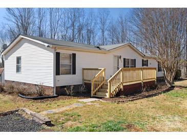 Charming single-story home with a welcoming front porch and well-maintained landscaping at 109 Fish Hill Dr, Statesville, NC 28677