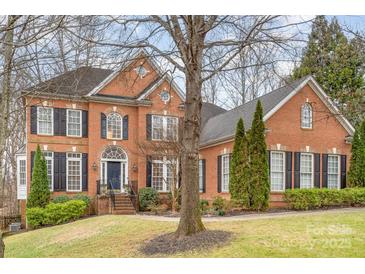 Elegant brick home with black shutters, arched entry, and well-maintained landscaping at 140 Melbourne Dr, Fort Mill, SC 29708