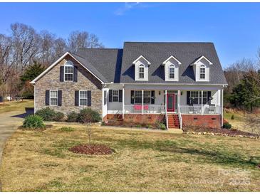 Charming two-story home with a stone and white facade, front porch, and well-manicured lawn at 1796 Williamsburg Dr, Rock Hill, SC 29732