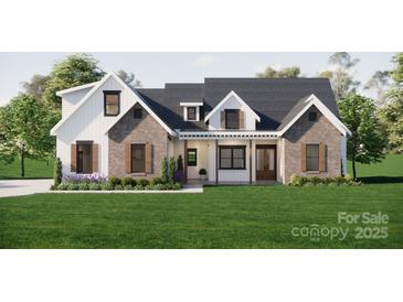 Charming modern farmhouse-style home with a well-manicured lawn, and brick and white siding at 2910A Williams Rd, Matthews, NC 28105