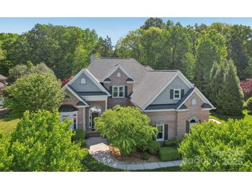 Charming two-story brick home with lush landscaping and a welcoming front entrance at 820 Hampshire Hill Rd # 106, Matthews, NC 28105