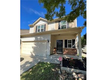 Charming two-story home featuring a two-car garage, welcoming entrance, and beautifully landscaped front yard at 14331 Evening Flight Ln, Charlotte, NC 28262