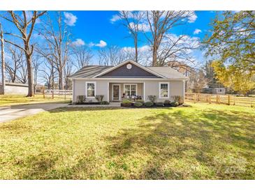 Charming one-story home featuring a well-manicured lawn, inviting entrance, and a partially fenced yard at 2625 Larry Dr, Charlotte, NC 28214