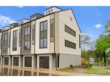 Modern townhome showcasing mixed panel siding, black framed windows, and a convenient one car garage at 3206 Riley Ave, Charlotte, NC 28269