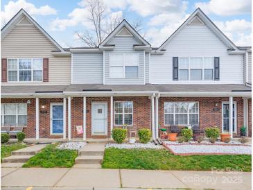 Charming brick townhome featuring manicured landscaping and inviting front porches at 331 Wilkes Place Dr, Fort Mill, SC 29715