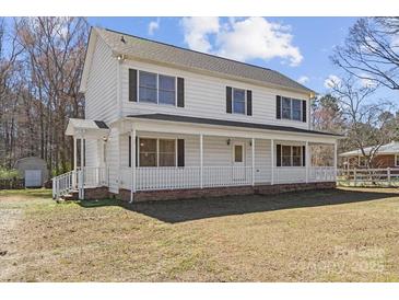 Charming two-story home with a inviting front porch and classic design at 5902 Mt Holly Huntersville Rd, Charlotte, NC 28216