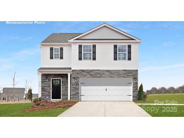 Two-story home featuring stone accents, a two-car garage, black shutters, and a well-manicured lawn at 8043 Plymouth Rd, Sherrills Ford, NC 28673