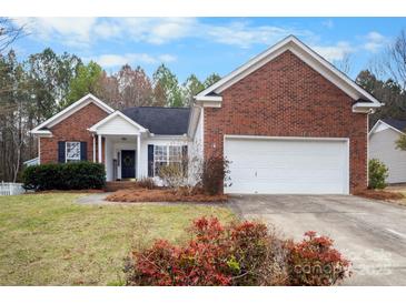 Charming brick home with a well-manicured lawn and inviting front entrance at 8211 Poplar Grove Cir # 31, Waxhaw, NC 28173